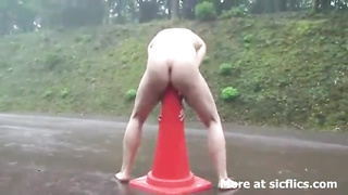 Whorish stunner is attempting to rail a road cone and groaning from sheer pleasure while spunking