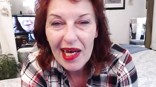 Whorey grannie with crimson hair is deep throating a faux man meat, in front of the camera