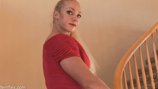 Bulky, German blond is posing in a crimson sundress, while no one else is at home