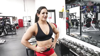 Beefy dark haired is raising weights in front of the camera, because it arouses her a plenty of