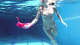 Supah warm teenager is pawing her love button and rubdown her honeypot under the water, in the pool