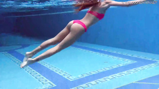 Supah warm teenager is pawing her love button and rubdown her honeypot under the water, in the pool