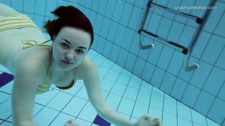 Uber-Cute dark-haired teenie loves swimming and diving nude in the pool, in the middle of the day