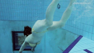 Uber-Cute dark-haired teenie loves swimming and diving nude in the pool, in the middle of the day