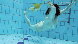 Uber-Cute dark-haired teenie loves swimming and diving nude in the pool, in the middle of the day