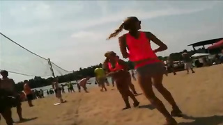 Mischievous fellow is filming some girl’s brilliant but in rosy bathing suit bottom while she plays waleyball