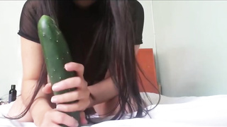 Petite jugged dark-haired in a sheer, black half-top, Miki Celeste is draining with a phat cucumber