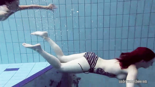 Ultra-Cute lezzies are swimming nude and rubbing each other, while no one is watchng them