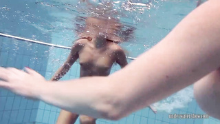 Ultra-Cute lezzies are swimming nude and rubbing each other, while no one is watchng them