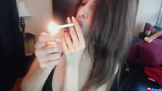 Splendid dark-haired is smoking in front of the camera, just because it turns her on