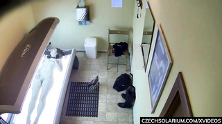 Scarcely college-aged stunner is massaging her wetting raw cunt in the solarium and getting well-prepped to jism