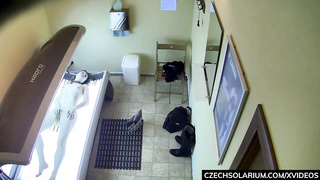 Scarcely college-aged stunner is massaging her wetting raw cunt in the solarium and getting well-prepped to jism