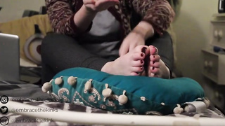 Ultra-Kinky teenager black-haired is showing her feet in front of the web camera, once in a while