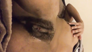 Ebony lady is frolicking with her shaved cooter and attempting to make a movie while doing it