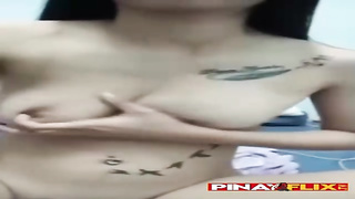 Buxom Pinay dark-haired with tats is kneading herself in front of the camera and lovin’ it