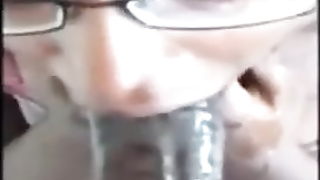 Stunner with glasses is gargling a thick, black knob as deep as she can, just for joy