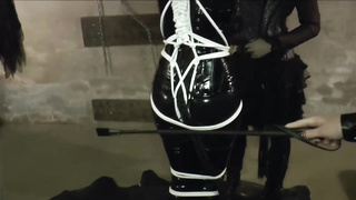 Cat Chick is dressed in her wonderful, spandex costume while being corded up and tormented by 2 nymphs