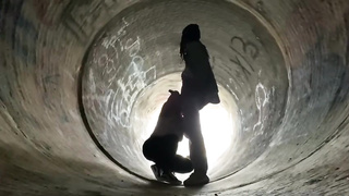 Inexperienced doll is getting on all fours on the ground and deep throating a rock rigid boner in a public place