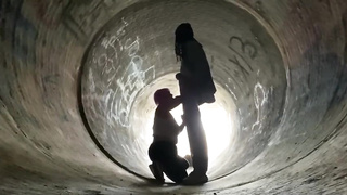 Inexperienced doll is getting on all fours on the ground and deep throating a rock rigid boner in a public place