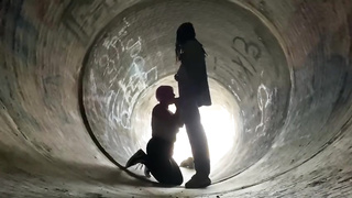 Inexperienced doll is getting on all fours on the ground and deep throating a rock rigid boner in a public place