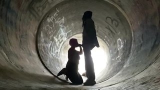 Inexperienced doll is getting on all fours on the ground and deep throating a rock rigid boner in a public place