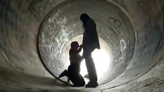 Inexperienced doll is getting on all fours on the ground and deep throating a rock rigid boner in a public place