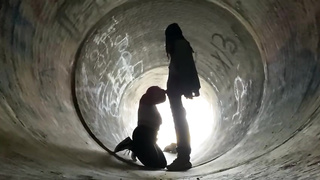 Inexperienced doll is getting on all fours on the ground and deep throating a rock rigid boner in a public place