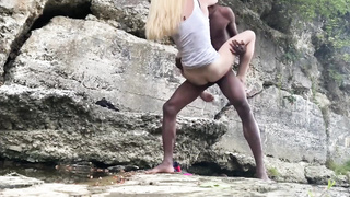 Excited, white light-haired is shagging a black stud during the hiking journey, in the afternoon