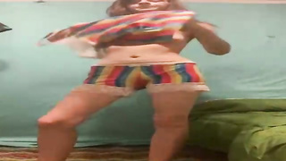 Luxurious dame is leisurely taking off her clothes in front of the camera, just for joy