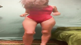 Luxurious dame is leisurely taking off her clothes in front of the camera, just for joy