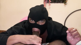 Hooded Ebony gal is fellating a firm penis in a POINT OF VIEW fashion, in front of the camera