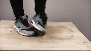 Accomplished nymph is dressed in sports boots while providing a feetjob to a boy from the surroundings