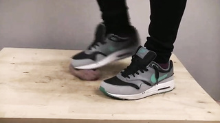 Accomplished nymph is dressed in sports boots while providing a feetjob to a boy from the surroundings