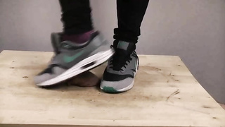 Accomplished nymph is dressed in sports boots while providing a feetjob to a boy from the surroundings