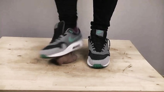 Accomplished nymph is dressed in sports boots while providing a feetjob to a boy from the surroundings