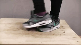 Accomplished nymph is dressed in sports boots while providing a feetjob to a boy from the surroundings