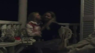 Excited lesbos began making out on the balcony and shortly they were tonguing each other up