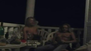 Excited lesbos began making out on the balcony and shortly they were tonguing each other up