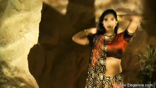 Handsome, Indian brown-haired is dancing and leisurely taking off her clothes, in the middle of the night
