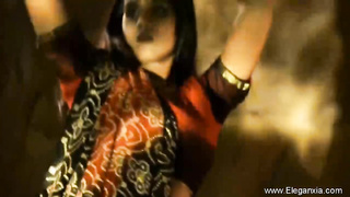 Handsome, Indian brown-haired is dancing and leisurely taking off her clothes, in the middle of the night