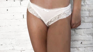 Slender teenie in jaw-dropping, white underwear is posing and taunting in front of the camera