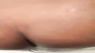 Ebony PLUS-SIZE is usinga immense, glass fuck stick while milking in front of the camera