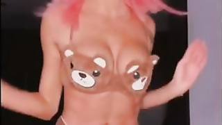 Rosy haired honey is posing and taunting in front of the web camera and liking it