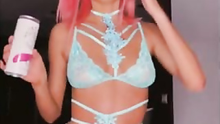 Rosy haired honey is posing and taunting in front of the web camera and liking it