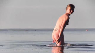 Slender teenage loves to be bare on the beach in the middle of the day
