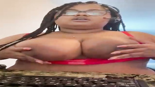 Big-Titted Ebony gal in softcore, crimson underwear is posing and taunting in front of the camera