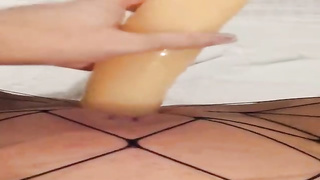 Insane female is dressed in black fishnets while frolicking her soddening raw muff with a enormous dldo