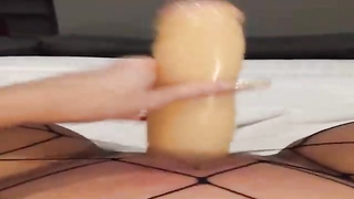 Insane female is dressed in black fishnets while frolicking her soddening raw muff with a enormous dldo