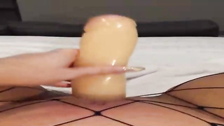 Insane female is dressed in black fishnets while frolicking her soddening raw muff with a enormous dldo