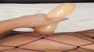 Insane female is dressed in black fishnets while frolicking her soddening raw muff with a enormous dldo